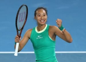 Zheng Qinwen levantando el puño tras ganar un partido de tenis